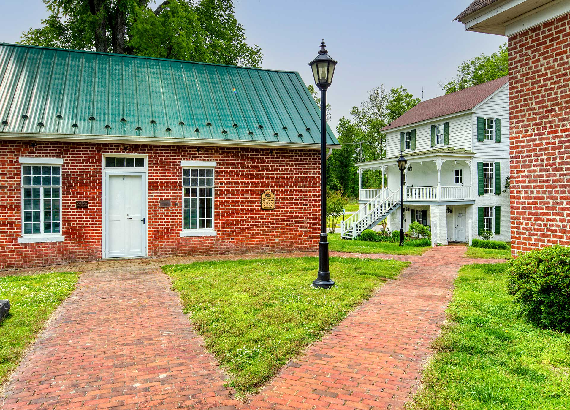 Red brick government buildings with walkways and green roofs in King and Queen County